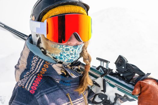 Young woman on a ski vacation in the mountains, portrait. Great rider holiday in ski resort.