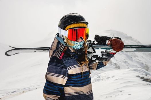 Young woman on a ski vacation in the mountains, portrait. Great rider holiday in ski resort.