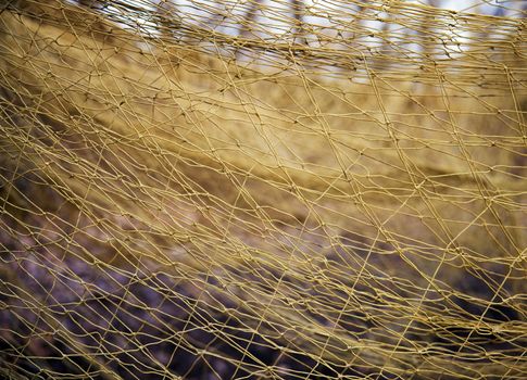 Large mesh net for catching animals. Rescue and relocation of animals. Background from the net. Nets for catching wild animals in the forest. Trapping game animals. Unraveling trapping nets.