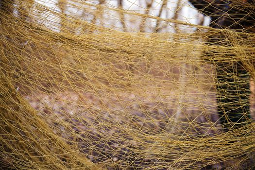 Large mesh net for catching animals. Rescue and relocation of animals. Background from the net. Nets for catching wild animals in the forest. Trapping game animals. Unraveling trapping nets.