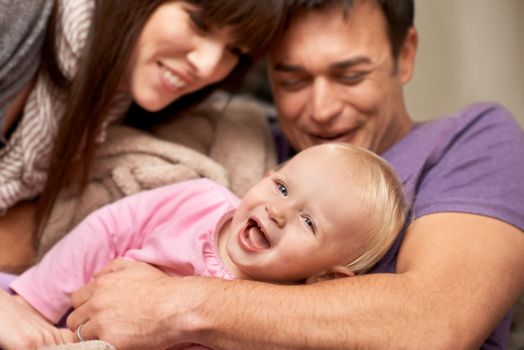 Happy family. a young couple playing with their infant daughter