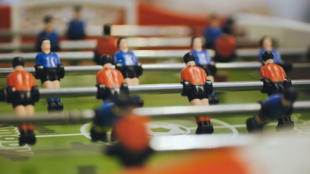 Players play table football in the clubhouse