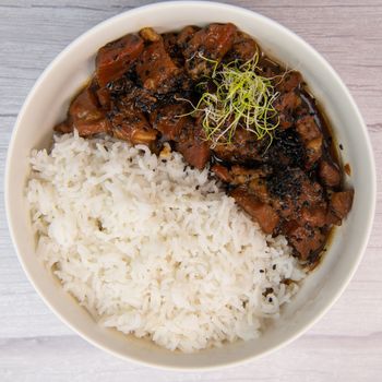 Caramel pork recipe with rice and black sesame seeds. High quality photo