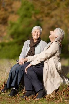 Thats hilarious. Two senior women laughing while sitting outdoors together
