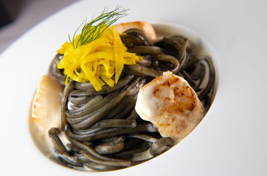 Recipe for Linguine Pasta with squid ink and scallops, yellow chioggia beet. High quality photo