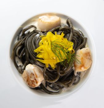 Recipe for Linguine Pasta with squid ink and scallops, yellow chioggia beet. High quality photo