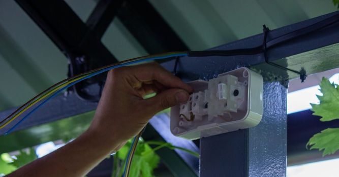 electrician to connect the outlet. selective focus