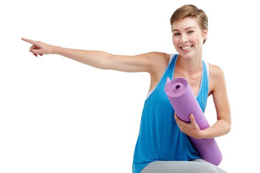 Yoga, pointing and woman isolated on a white background with training gear for product placement on mockup. Happy fitness, exercise or workout person in pilates, sports portrait show space in studio.