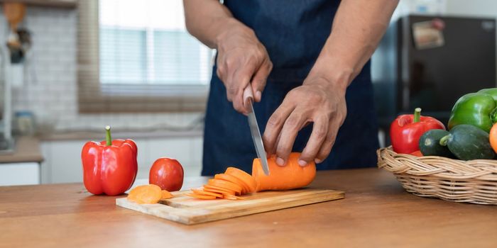 Man preparing delicious and healthy food in the home kitchen.