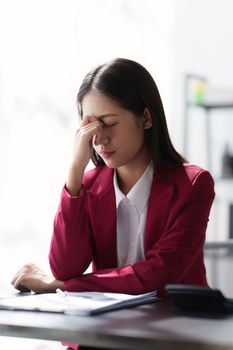 Stressed Business woman checking budget of company, taxes, bank account balance and calculating expenses at office.