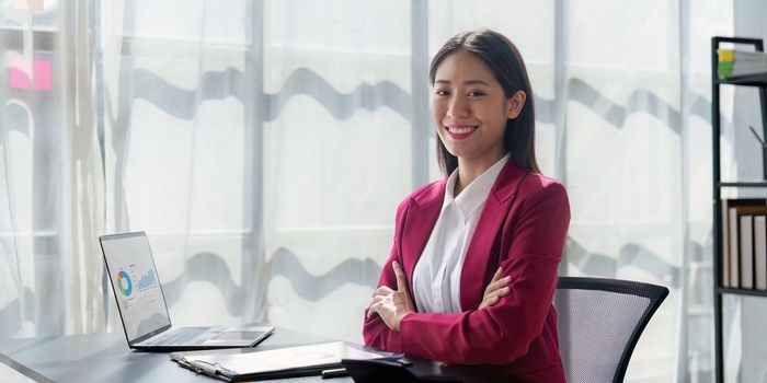 Asian Business woman working at home office and analyze financial report document. Accounting and Finance concept.