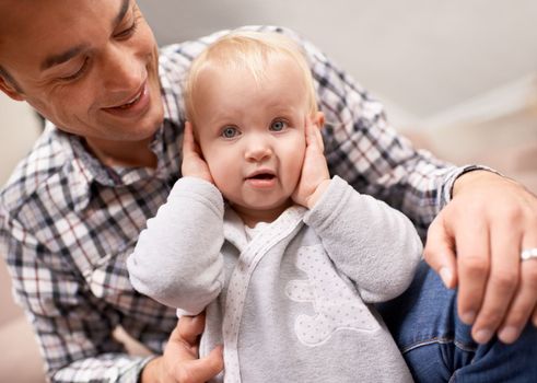 Admiring his beautiful daughter. A young father spending quality time his baby daughter