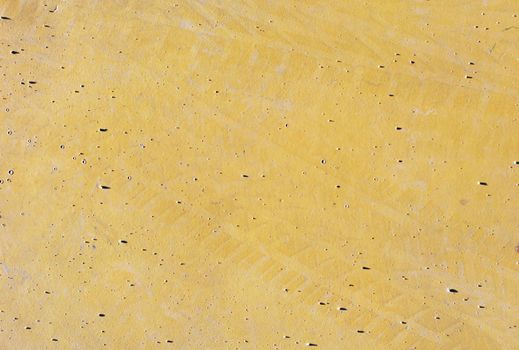 Top view of textured background of smooth surface of yellow color