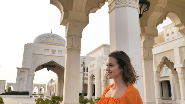 Girl posing against the backdrop of Qasr Al Watan, UAE Presidential Palace in Abu Dhabi