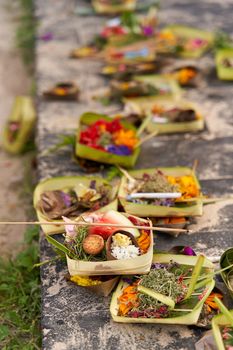 The layout on the ground of traditional offerings for the spirits on the island of Bali.