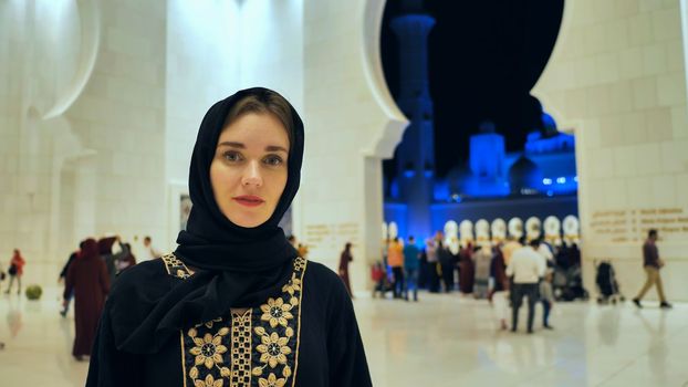 The girl examines the exhibits in the museum.Portrait of a girl in hijab in a mosque