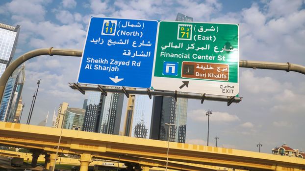 Dubai traffic signs over the road. United Arab Emirates