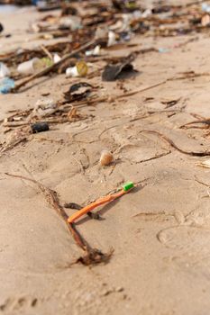 Mountains of waste and garbage on the sandy beach after the tide. Humanity is polluting the ocean.