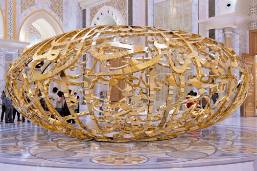 Abu Dhabi, Arab Emirates, March, 19, 2019. People walking near sculptural composition the power of words in Presidential Palace, Palace of Qasr al-Watan the Palace of the nation in Abu Dhabi
