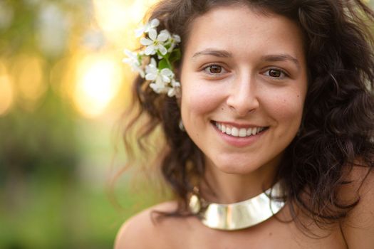 Portrait of a young laughing sexy brunette girl with a necklace around her neck.