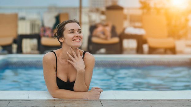 Girl after swimming posing in the pool