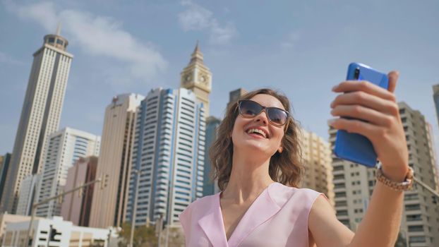 The girl is broadcasting live using a phone from Dubai