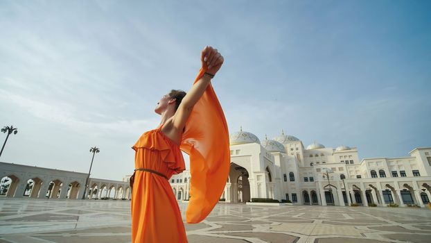 Girl posing on the background of the presidential palace in Abu Dhabi