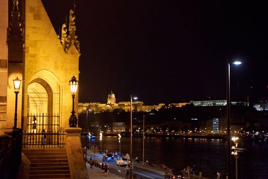 Evening photo of the Parliament building in Budapest.The majestic Saxon architecture is illuminated with warm yellow light. Budapest, Hungary - 08.24.2022