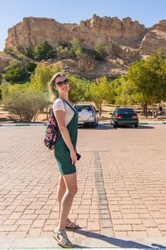 Tourist girl posing near hot thermal springs in the Arab Emirates near Ain Al