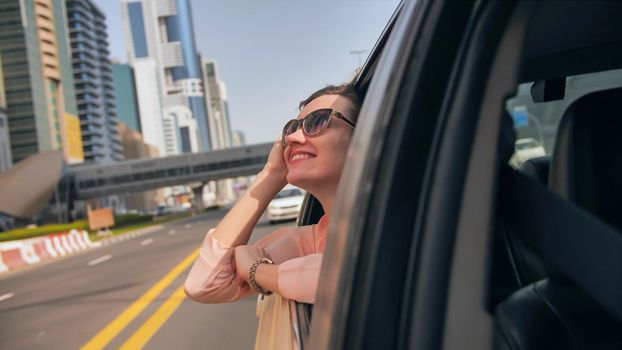 Happy Girl driving a car in Dubai
