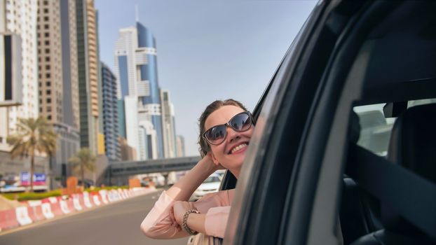 Happy Girl driving a car in Dubai. UAE