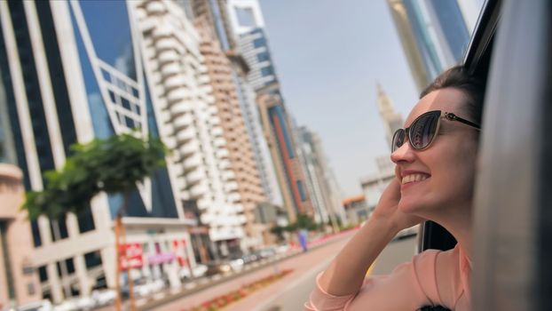 Happy Girl driving a car in Dubai. UAE