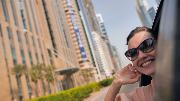 Happy Girl driving a car in Dubai. UAE