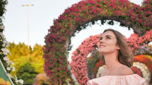 A girl walks through a fabulous park in Dubai