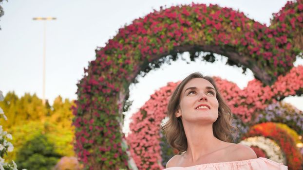 A girl walks through a fabulous park in Dubai