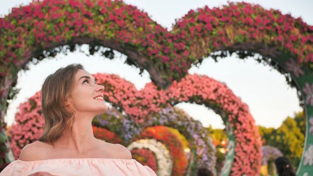 A girl walks through a fabulous park in Dubai