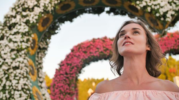A girl walks through a fabulous park in Dubai