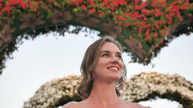 A girl walks through a fabulous park in Dubai