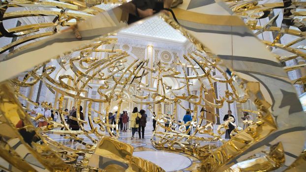 People walking near sculptural composition the power of words in Presidential Palace, Palace of Qasr al-Watan the Palace of the nation in Abu Dhabi