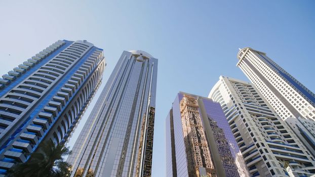 Tall and modern skyscrapers of Dubai on a sunny day