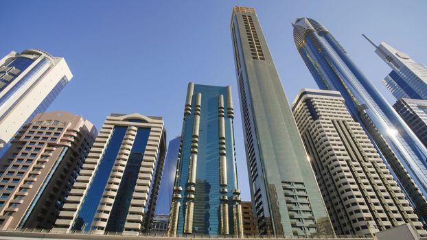 Tall and modern skyscrapers of Dubai on a sunny day