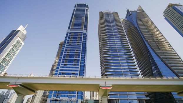 Tall and modern skyscrapers of Dubai on a sunny day