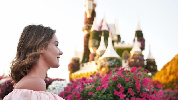 A girl walks through a beautiful fairytale park in Dubai