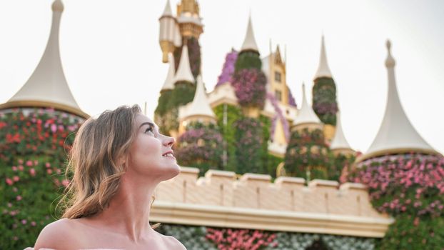A girl walks through a beautiful fairytale park in Dubai