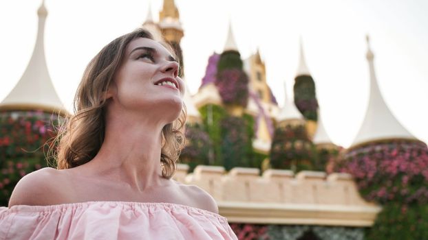 A girl walks through a beautiful fairytale park in Dubai
