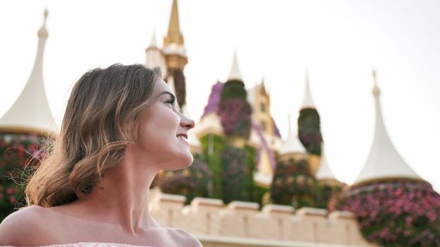 A girl walks through a beautiful fairytale park in Dubai
