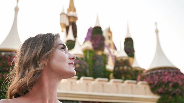 A girl walks through a beautiful fairytale park in Dubai