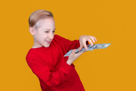 a child in red holds dollar bills