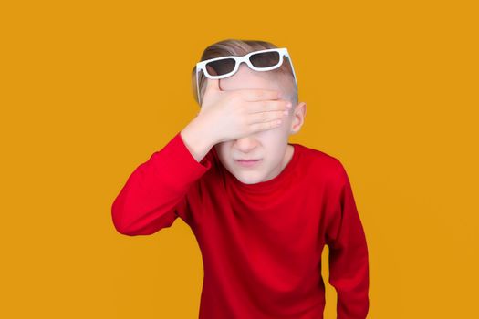 a child in children's 3D glasses covered his eyes with his hand