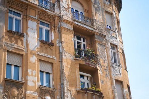 An old building with peeling paint in a European city.